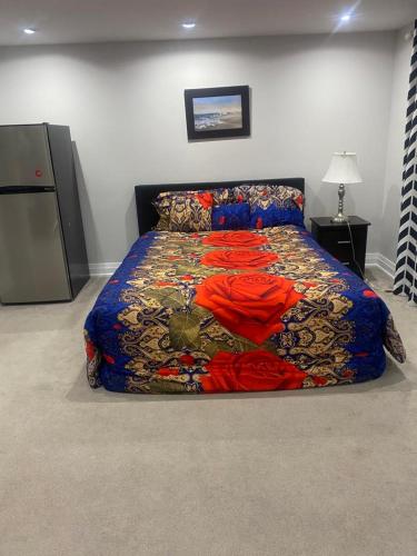 a bedroom with a bed with a colorful comforter at TREASURES HOME 5 in Brampton