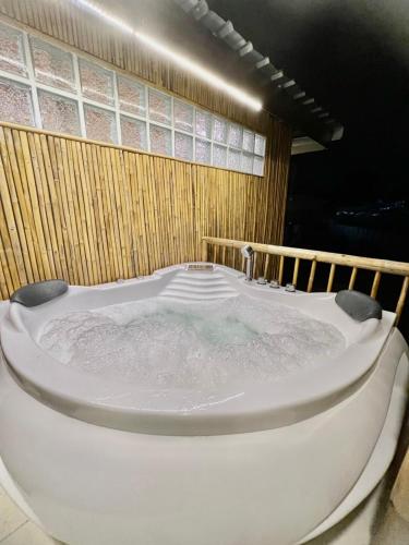 a jacuzzi tub in a room at Noree Deluxe in Ban Phan Sadet Nai