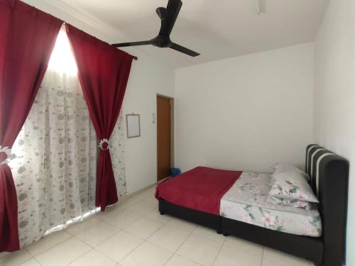 um quarto com uma cama e uma ventoinha de tecto em HOMESTAY HAIKALHAIDAR em Rantau Panjang