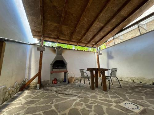 una mesa y sillas en una habitación con chimenea en Ninna House, en Villa San Sebastiano