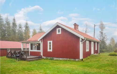 a red and white house with a grass yard at Cozy Home In Ryd With Wifi in Ryd