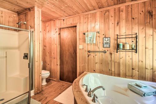 a bathroom with a tub and a toilet at Family Home with Stunning River and Mountain View in Priest River