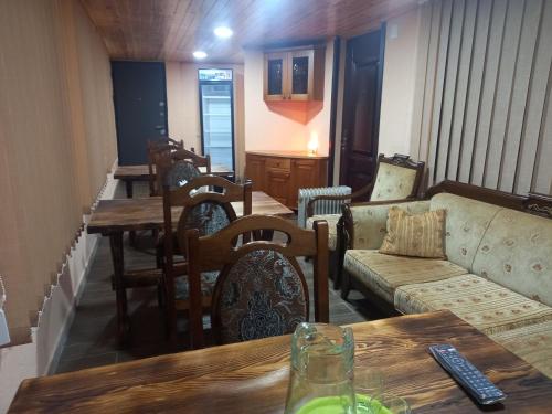 a living room with a couch and a table at Spardishi tower in Mestia