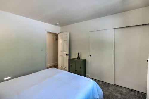 a bedroom with a white bed and a closet at Near Hiking and Yuba River Nevada City Retreat! in Nevada City
