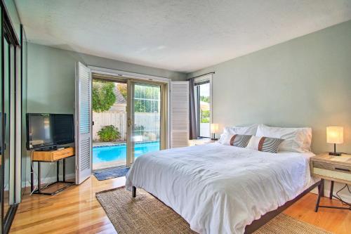 a bedroom with a large bed and a television at 2 Mi to South Cape Beach State Park Home with Yard! in Mashpee