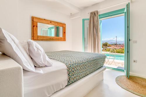 a bedroom with a bed and a view of a pool at Pandesia Villas Private Pools in Mármara