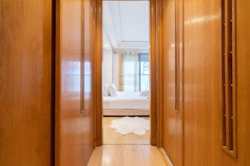 a hallway with a mirror and a bed in a room at Racine Two bedroom flat near twin center in Casablanca