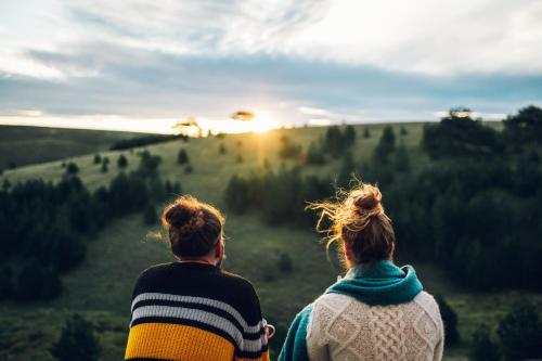 two women watching the sunset over a field at Wild nest Zlatibor Bear in Zlatibor