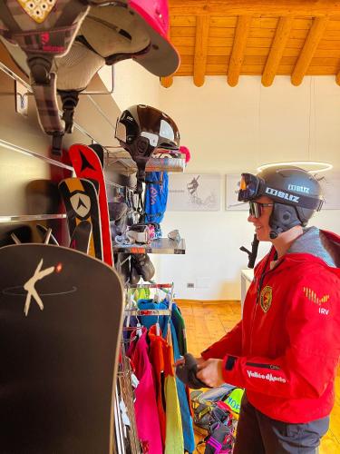 a man wearing a helmet standing in a room at Alp Apartments SKI & BIKE - Tourneuve5 in Aosta