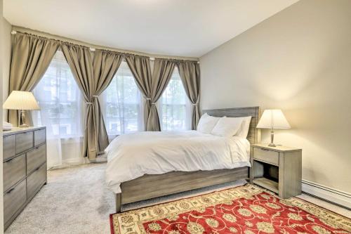 a bedroom with a large bed and two windows at Bright Springfield Apartment with 2 Balconies! in Springfield