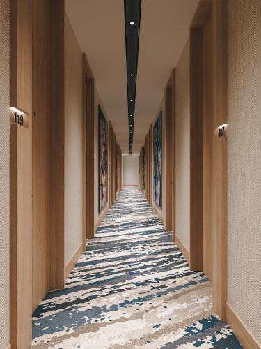 a hallway in a building with paintings on the walls at Fortune Walkway Mall, Haldwani - Member ITC Hotels' Group in Haldwāni
