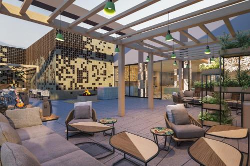 a patio with chairs and tables and a fireplace at Fortune Walkway Mall, Haldwani - Member ITC Hotels' Group in Haldwāni
