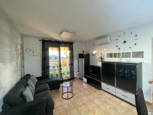 a living room with a couch and a tv at el toro in Finestrat