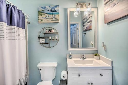 a bathroom with a white toilet and a sink at Barefoot Landing Retreat with Resort Amenities! in Myrtle Beach