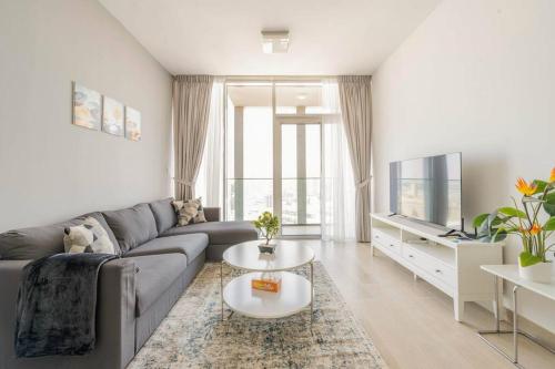 a living room with a couch and a table at High floor 1BR vacation home with terrace in Dubai