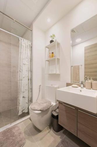 a bathroom with a toilet and a sink and a shower at High floor 1BR vacation home with terrace in Dubai