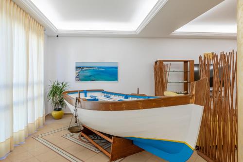 a boat is on display in a room at Hotel Sabbia d'Oro in San Vito lo Capo