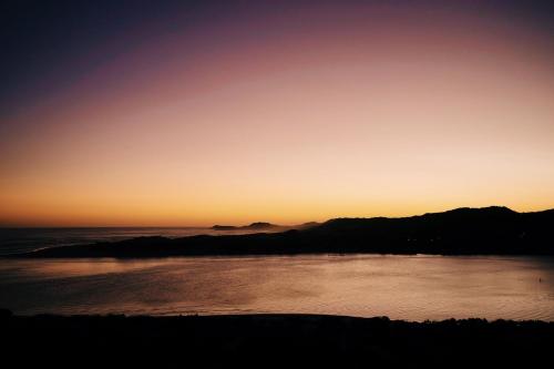 a view of the ocean at sunset at The Oyster Box Beach House by The Oyster Collection in Kenton on Sea