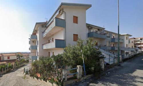 a building with balconies on the side of a street at Аppartamenti per vacanze, 500 m dal mare in Scalea
