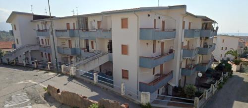 a building with blue balconies on the side of it at Аppartamenti per vacanze, 500 m dal mare in Scalea