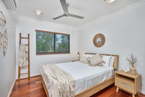 a bedroom with a bed and a ceiling fan at Stunning 2-3 Bed Penthouse Glorious Ocean Views in Trinity Beach