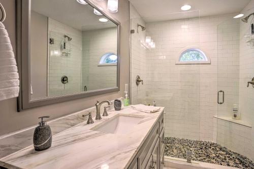 Un baño con lavabo y un espejo grande. en Riverfront Retreat on 4 Acres with Private Dock, en Heathsville