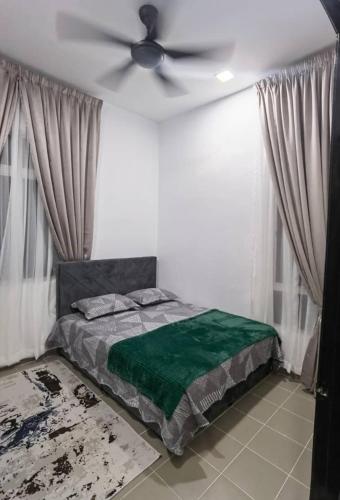 a bedroom with a bed with a ceiling fan at ZF Homestay in Kota Bharu