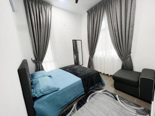a bedroom with a bed and a chair and windows at ZF Homestay in Kota Bharu