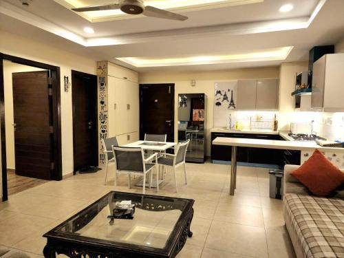 a living room with a couch and a table at Bright & Beautiful 1 Bed Apt In Bahria Town in Rawalpindi