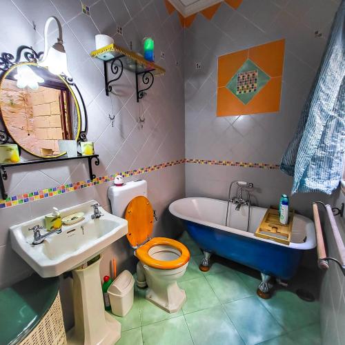 a bathroom with a tub and a toilet and a sink at 1500 Little Pink House in Kalkara Creek in Kalkara