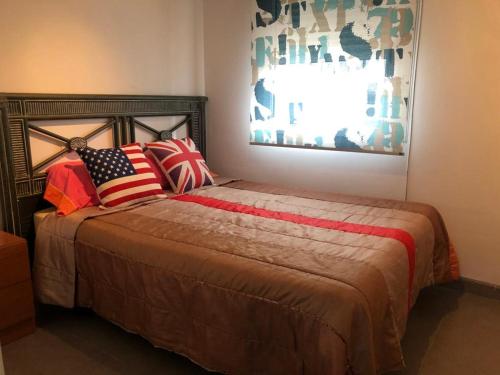 a bedroom with a bed with patriotic pillows on it at MIRADOR MUDEJAR in Teruel