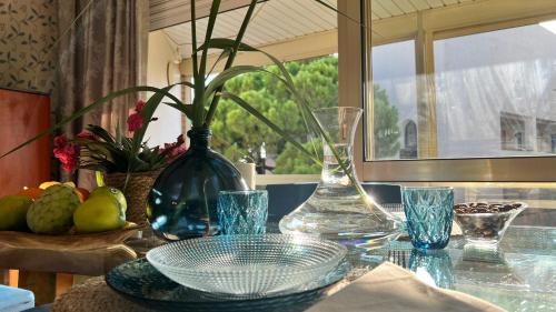 a glass table with a vase and glasses on it at Cambrils140 in Cambrils
