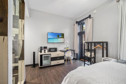 a bedroom with a bed and a desk and a table at Good Hotels Downtown Denver in Denver