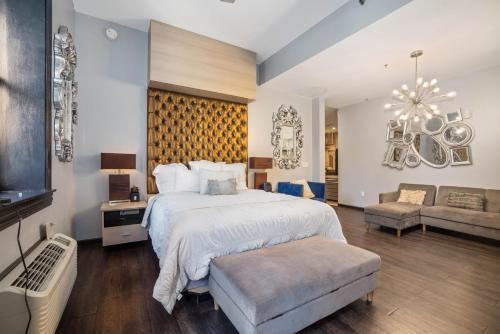 a large bedroom with a large bed and a couch at Good Hotels Downtown Denver in Denver