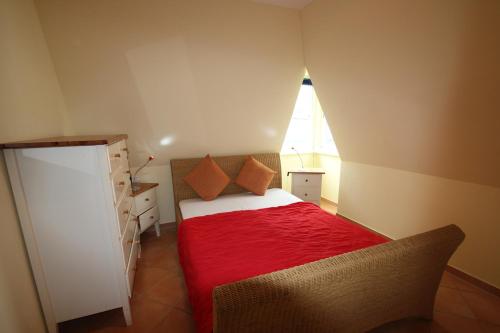 a small bedroom with a bed and a window at Villa Ambienta WE 7 in Binz