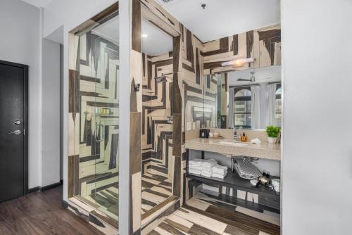 a bathroom with a large wooden wall with a mirror at Good Hotels Downtown Denver in Denver
