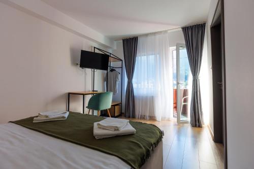 ein Schlafzimmer mit einem Bett mit zwei Handtüchern darauf in der Unterkunft The Bear House 2 in Buşteni
