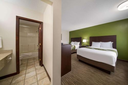 a hotel room with a bed and a bathroom at Quality Inn in Great Barrington