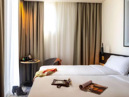 um quarto de hotel com duas camas com uma bandeja na cama em ibis Brussels Groot Bijgaarden em Groot-Bijgaarden
