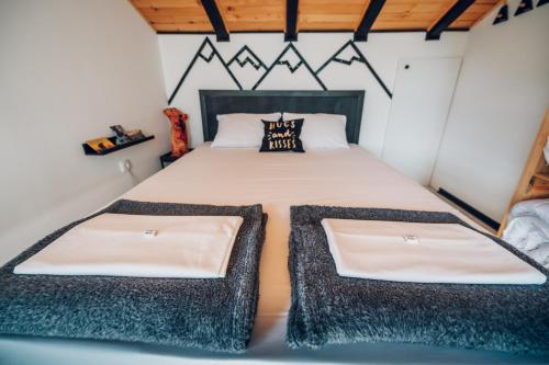 a bedroom with a large bed with two pillows at Zlatibor Wild nest Rabbit in Zlatibor