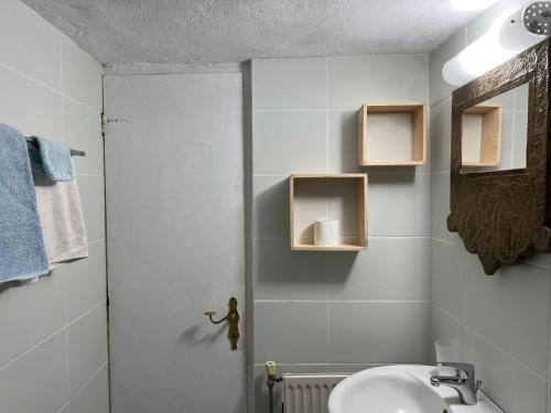 a white bathroom with a sink and a mirror at B&B Monastiriako in Giannoudi