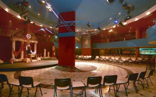 a large room with a stage with chairs in it at Rubi Hotel in Avsallar