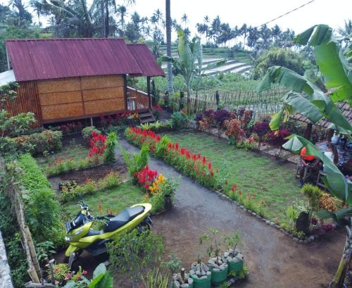 a garden with a small building and a boat in it at Kurni's Cabin in Sapit