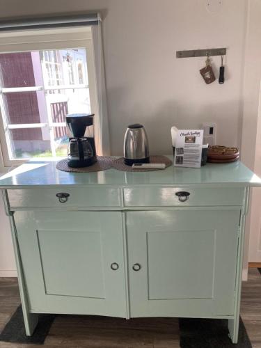 a white cabinet with a blue counter top at Ankiborg Bed and Breakfast in Färjestaden