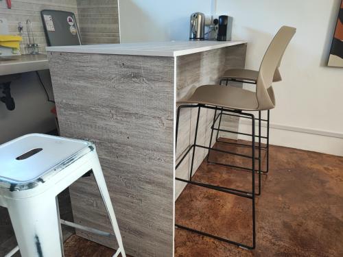 a kitchen with a counter and a stool and a counter top at Ti Pavillon in Rodrigues Island