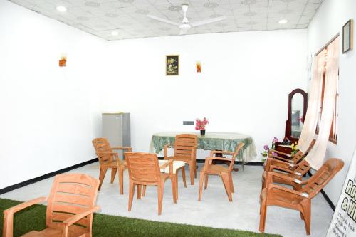 a dining room with a table and chairs at Tharaka Homestay in Weligama