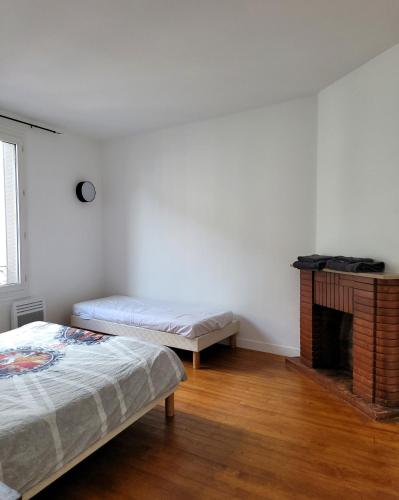 Posteľ alebo postele v izbe v ubytovaní Appart95 Saint-Brice CDG France