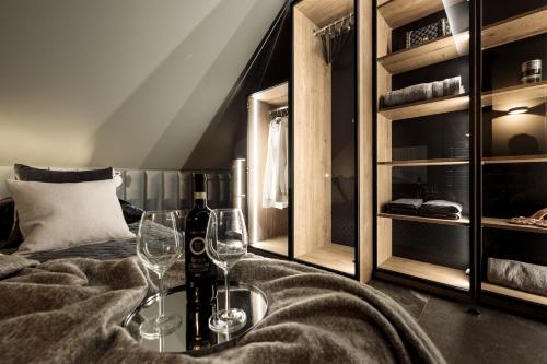 a room with a bed with wine glasses on a table at MS Wielka Odrzańska Old Town Apartment in Szczecin