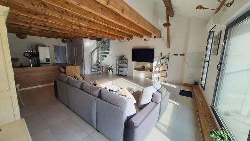 a living room with two couches and a television at Beau T4 au cœur du centre ville in Narbonne