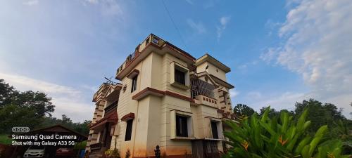 a tall building with a sky in the background at Shree Homestay in Manipala